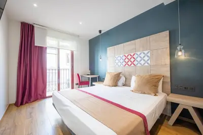a bedroom with a large bed and a window at Boutique Hostemplo Sagrada Familia in Barcelona