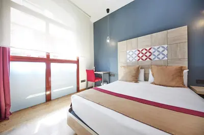 a bedroom with a large bed and a window at Boutique Hostemplo Sagrada Familia in Barcelona