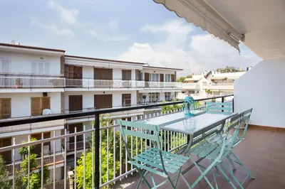a balcony with a table and chairs on a building at Stay U-nique Apartments Sitges Beach in Sitges