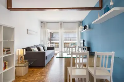 a living room with a couch and a table and chairs at Stay U-nique Apartments Sitges Beach in Sitges