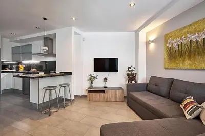 a living room with a couch and a kitchen at BBarcelona Brusi Flat in Barcelona