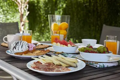 a table with plates of food and fruit on it at BBarcelona Brusi Flat in Barcelona