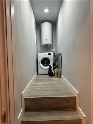 a hallway with a washing machine in a room at studio Espania in Hospitalet de Llobregat