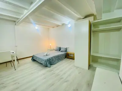 a bedroom with a bed and a desk in it at 11 Principal Barca in Barcelona