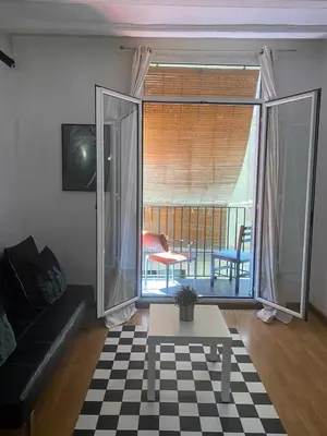 a living room with a couch and a table at Loft Center Rambla in Barcelona