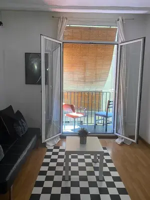 a living room with a couch and a table at Loft Center Rambla in Barcelona