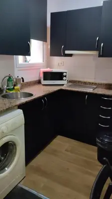 a kitchen with a sink and a microwave on a counter at Loft Center Rambla in Barcelona