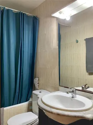 a bathroom with a sink and a toilet and a mirror at Loft Center Rambla in Barcelona