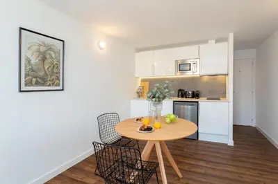 a kitchen with a table with fruit on it at Sunshine Studios Portside Gothic in Barcelona