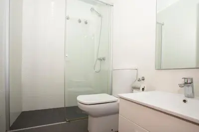a bathroom with a shower and a toilet and a sink at Radiant Vista Apartment Eixample in Barcelona