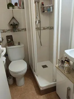 a white bathroom with a toilet and a shower at Habitación individual acogedora in Barcelona