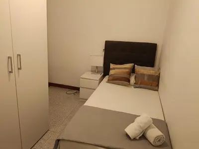 a bedroom with a bed with two pillows at Habitación individual acogedora in Barcelona