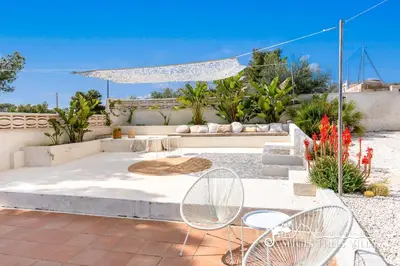 a villa with a swimming pool and a house at Villa Caliza in Cunit with Private Pool and large garden - air conditioning in bedroom in Cunit