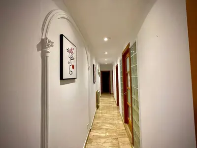 a hallway with white walls and a tile floor at Precioso y espacioso piso in Arenys de Mar