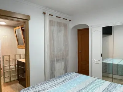 a bedroom with a bed and a closet and a door at Precioso y espacioso piso in Arenys de Mar