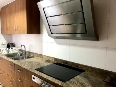 a kitchen with a sink and a microwave at Vivalidays - Estrella de Mar - Calella in Calella