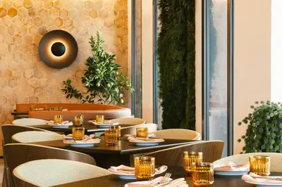 a restaurant with tables and chairs with glasses on them at The Social Hub Barcelona Poblenou Extended Stay in Barcelona