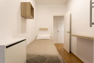 a small room with a bed in a kitchen at Gran Vía Suites in Barcelona