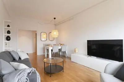 a living room with a couch and a tv at Gran Vía Suites in Barcelona