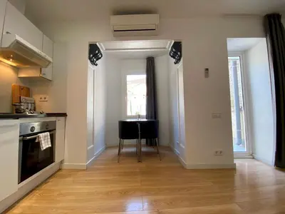 a kitchen with a table in the middle of a room at PISO FILIPPO in Barcelona