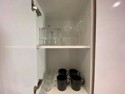 a cupboard with glasses and mugs in it at PISO FILIPPO in Barcelona