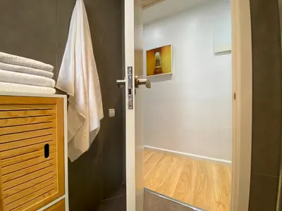 a bathroom with a walk in shower next to a door at PISO FILIPPO in Barcelona