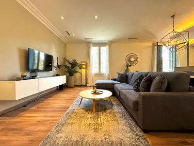 a living room with a couch and a tv at MODERN ELEGANCE by MyRentalHost in Barcelona