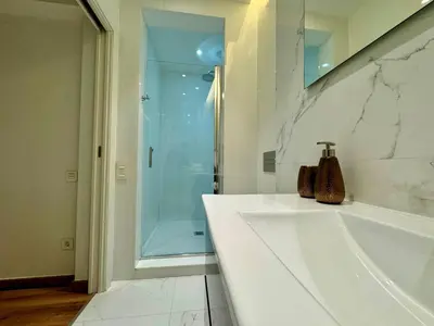 a bathroom with a shower and a white bath tub at MODERN ELEGANCE by MyRentalHost in Barcelona