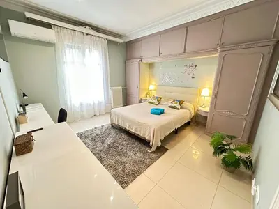 a bedroom with a bed and a large window at Rooms Granvia in Barcelona