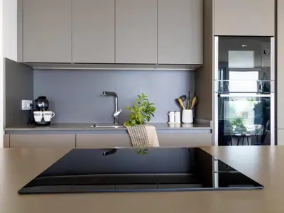 a kitchen with white cabinets and a sink at Seafront Apartment in Calella with Beach Access in Calella