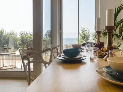 a dining room table with a view of the ocean at Seafront Apartment in Calella with Beach Access in Calella