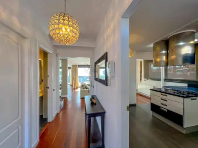 a kitchen with a table in the middle of a room at Stylish villa with saltwater pool in Caldes d'Estrac