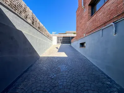 a brick alley way between two buildings at Stylish villa with saltwater pool in Caldes d'Estrac