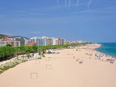 a beach with a lot of people and the ocean at Apartment in Calella near the Beach in Calella