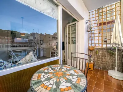 a balcony with a table and a large window at Apartment in Calella near the Beach in Calella