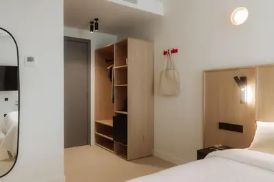 a bedroom with a bed and a closet at Design Suites by Olala Homes in Hospitalet de Llobregat