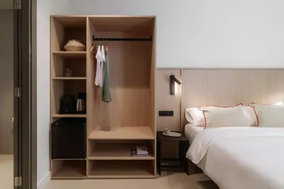 a bedroom with a bed and a closet at Design Suites by Olala Homes in Hospitalet de Llobregat