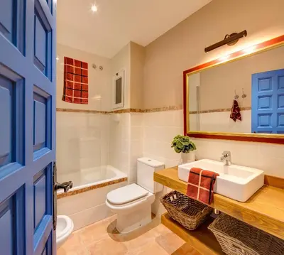 a bathroom with a white toilet and a sink at Blue Home in Sitges
