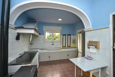 a kitchen with a sink and a table in it at TURISME RURAL HORTA del PI in Cabrera de Mar