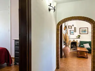 a hallway with an archway in a living room at Tranquil Villa with Private Pool & views in Sant Cebrià de Vallalta