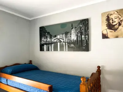 a bedroom with a bed and a picture on the wall at Tranquil Villa with Private Pool & views in Sant Cebrià de Vallalta