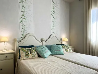 a bedroom with a white bed with pillows on it at Tranquil Villa with Private Pool & views in Sant Cebrià de Vallalta