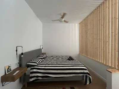a bedroom with a bed with black and white stripes at Son Roca Ribes Guest House in Sant Pere de Ribes