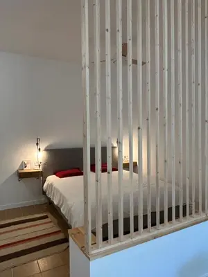 a bedroom with a bed with white rails at Son Roca Ribes Guest House in Sant Pere de Ribes
