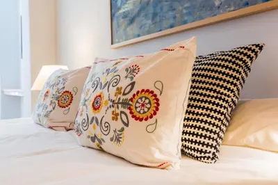 a group of pillows sitting on top of a bed at Provenza Flat in Barcelona