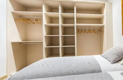a bedroom with a bed with white shelves at Provenza Flat in Barcelona