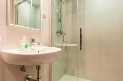 a bathroom with a sink and a shower at Provenza Flat in Barcelona