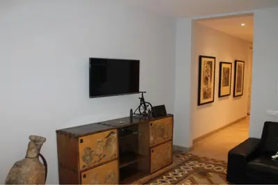 a living room with a tv on a wall at Provenza Flat in Barcelona