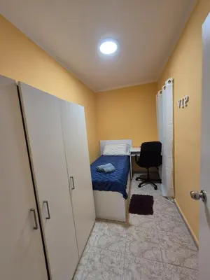 a small room with a bed and a desk at Marry home in Barcelona
