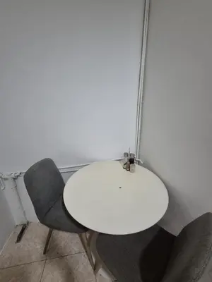 a white table and two chairs in a room at Marry home in Barcelona